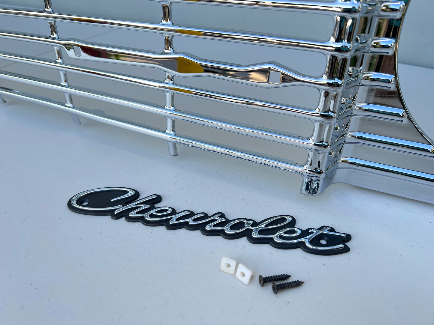 1964 CHEVY IMPALA / FULL SIZE FRONT GRILLE EMBLEM CHEVROLET SCRIPT W/ HARDWARE (NEW)