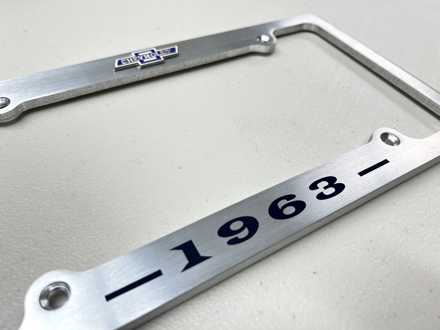 1963 CHEVROLET IMPALA, BEL AIR, BISCAYNE BRUSHED ALUMINUM LICENSE PLATE FRAME WITH BOWTIE LOGO